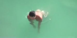Nudist woman refreshing in the water