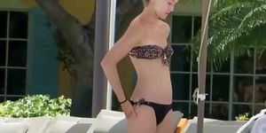 Teen rubs herself with lotion by the pool