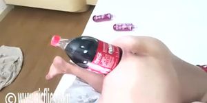 Big soda bottle is penetrating her tight asshole