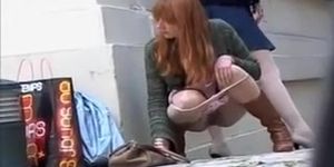 Zoom on a redhead girl pissing in an alley