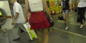 Her red skirt attracts attention of upskirt voyeur guy