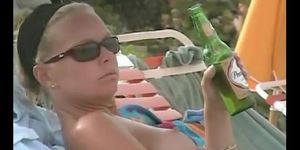 Hot video of a mature woman reading a book on a nudist beach
