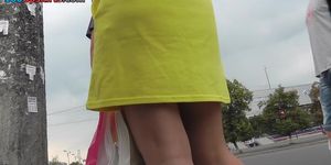 Hot upskirts with slender brunette in yellows dress