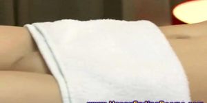 Masseur uses feet on model during her massage session