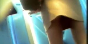 Sexy butted gal lifts and skirt and pisses on toilet spy cam
