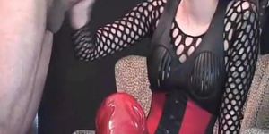 Lady in high red boots doing handjob