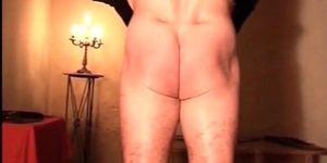 Totally nude guy has hands tied and ass spanked