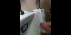 two slim dicks getting wanked at the urinals