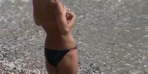 Slim teen with perky tits naked at a nudist beach