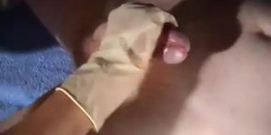 Nurse in latex gloves gives a handjob