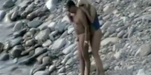 Nudist fucked rough on rocky beach