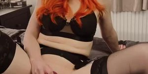 redhead plays with toy in lingerie