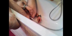 Bi-guy using shower head squirting water enema