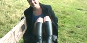 Redhead in boots flashing outdoors
