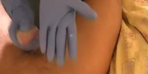 She gives him a handjob with rubber gloves