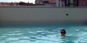 Topless cutie takes a swim