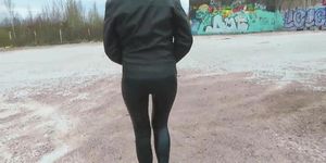 Sexy girl in a leather jacket and leggings shows her ass