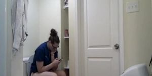 Chubby girl in glasses taking a long pee