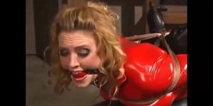 MILF in red catsuit hogtied and feet spank