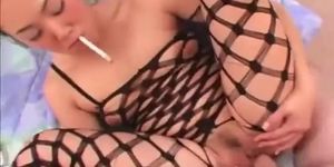 Nasty Asian slut smoking while sucking cock and in fishnet lingerie!