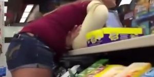 Teen in shorts bent over store counter