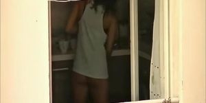 Voyeur films his hot neighbor in her kitchen