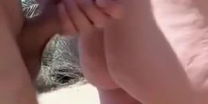 Beach handjob makes his hard cock cum