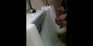 two slim dicks getting wanked at the urinals