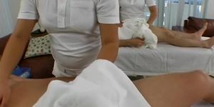 Asian masseuses tug on cocks of two white gentlemen