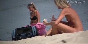 Voyeur beach nudist girl getting suntanned among bikini gals