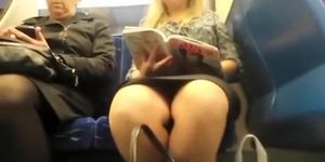 Woman reading a book in train upskirted