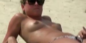 Topless blonde teen with small tits at beach