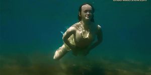 Hot girl swims in the sea like a mermaid