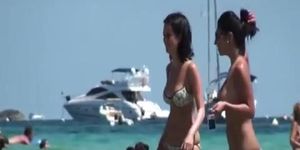 Two South European babes topless on the beach