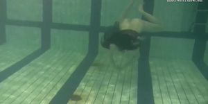 Dressed up teen Irina Barna swims sexy in the pool