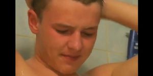 2 young boys having a cockfight in the shower