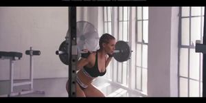 Fit girl lifts a heavy black whang (Nicole Aniston)