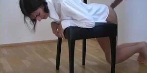 Bottomless schoolgirl bends over a chair for a whoopin