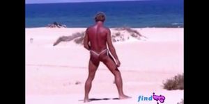 Tanned guy on beach in tiny string thong temporarily