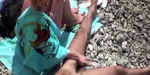 Wife strokes mans penis in beach