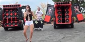 Teen Latina dancing and singing in a parking lot