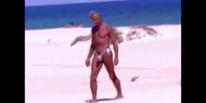 Tanned guy on beach in tiny string thong temporarily