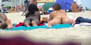 Naked black and white women filmed at the beach
