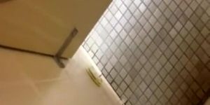 Voyeur strokes dick while woman peeing