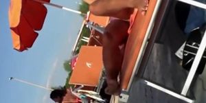 Milf lying by the pool and touching pussy
