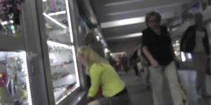 Upskirt shot of round ass of a window-shopping blonde