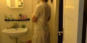 Nurse with her wet uniform in bathroom