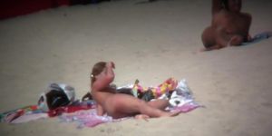 Brunette cutie with a perky butt filmed on a nudist beach