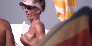 Very horny milf rubbing tits in nude beach