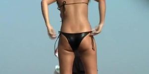 Shiny black bikini on a sweetie at the beach